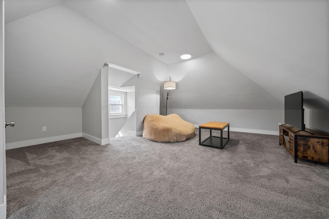 sitting room with baseboards, carpet floors, and vaulted ceiling