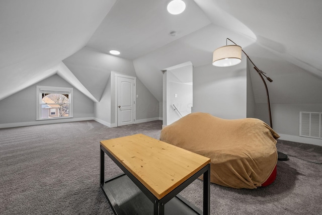 sitting room with visible vents, carpet flooring, baseboards, and vaulted ceiling