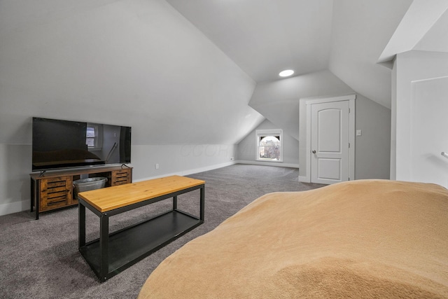 carpeted bedroom featuring baseboards and lofted ceiling