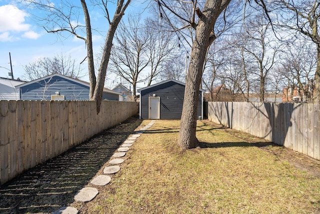 view of yard featuring an outbuilding and a fenced backyard