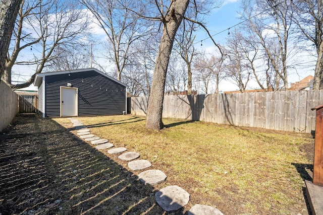 view of yard with an outdoor structure and a fenced backyard