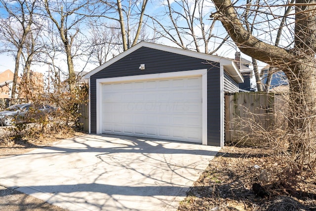 detached garage featuring fence