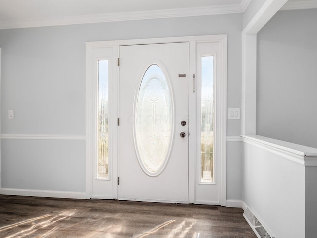 entrance foyer with ornamental molding, visible vents, plenty of natural light, and wood finished floors