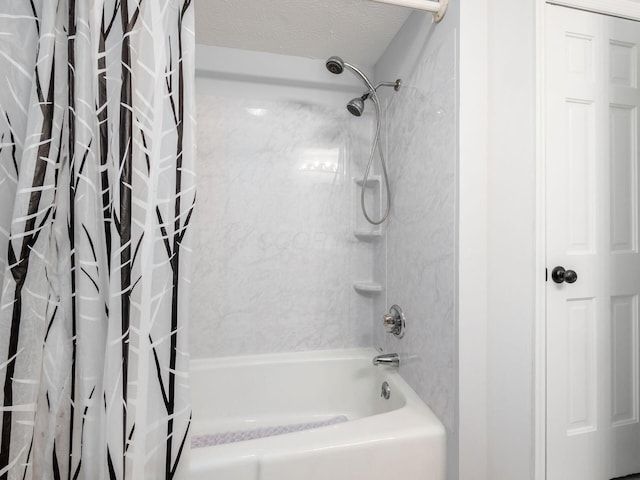 bathroom with a textured ceiling and shower / bath combination with curtain