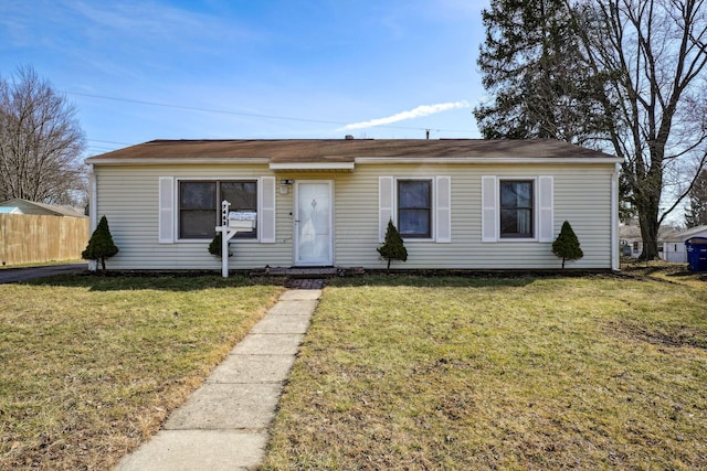 single story home featuring fence and a front lawn