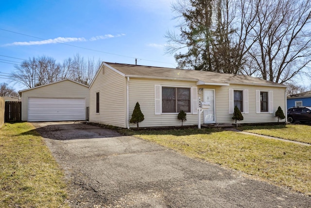 view of front facade with a garage, a front yard, an outdoor structure, and fence