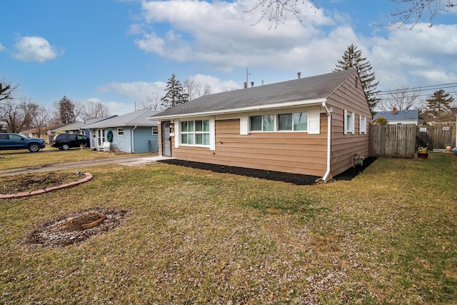 view of front of property with fence and a front lawn