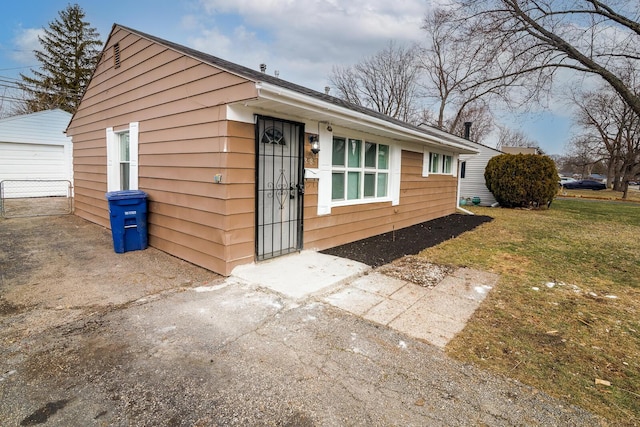 exterior space featuring a lawn and an outbuilding