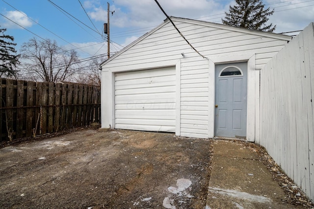 detached garage with fence and driveway