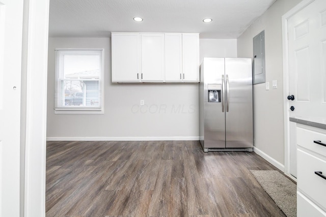 kitchen featuring white cabinets, baseboards, stainless steel refrigerator with ice dispenser, and dark wood-type flooring