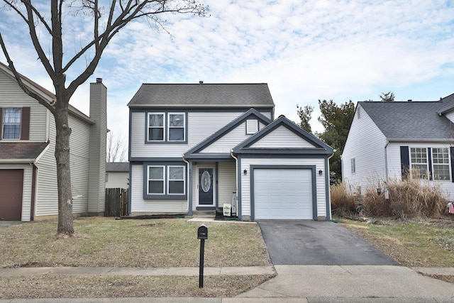 view of front of home with a garage, driveway, and a front lawn