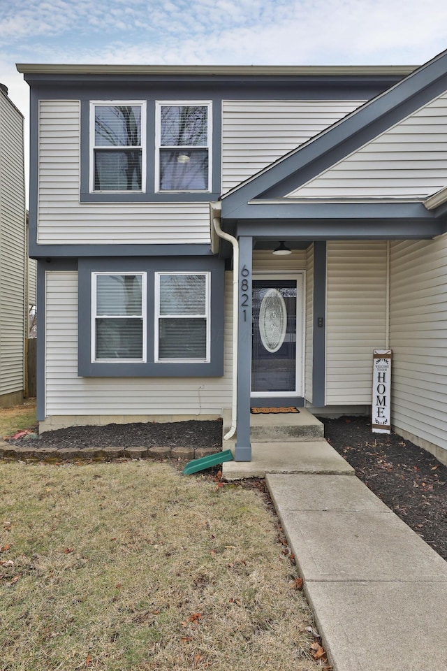 property entrance featuring a lawn