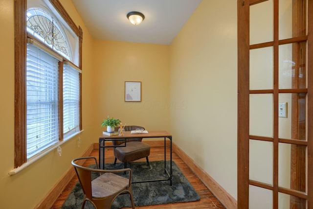 home office featuring baseboards and wood finished floors