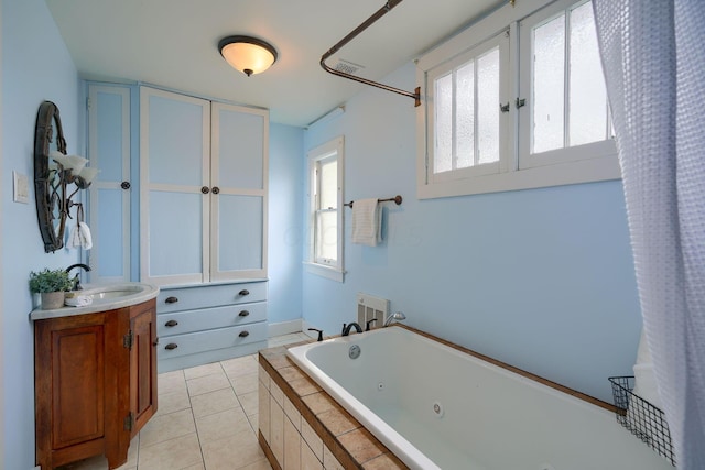 bathroom featuring a whirlpool tub, tile patterned flooring, visible vents, and vanity