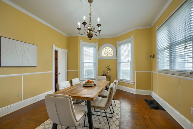 dining room with visible vents, crown molding, an inviting chandelier, and wood finished floors