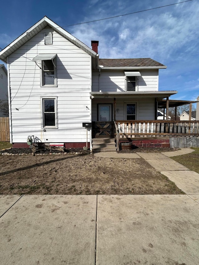 view of front of property with covered porch and a chimney