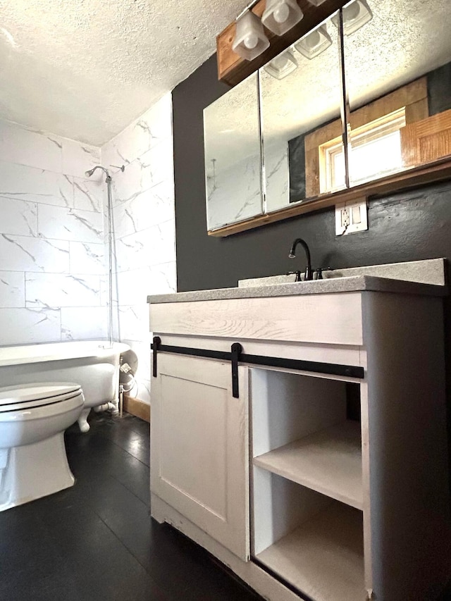 bathroom featuring a shower, toilet, a bathing tub, vanity, and a textured ceiling