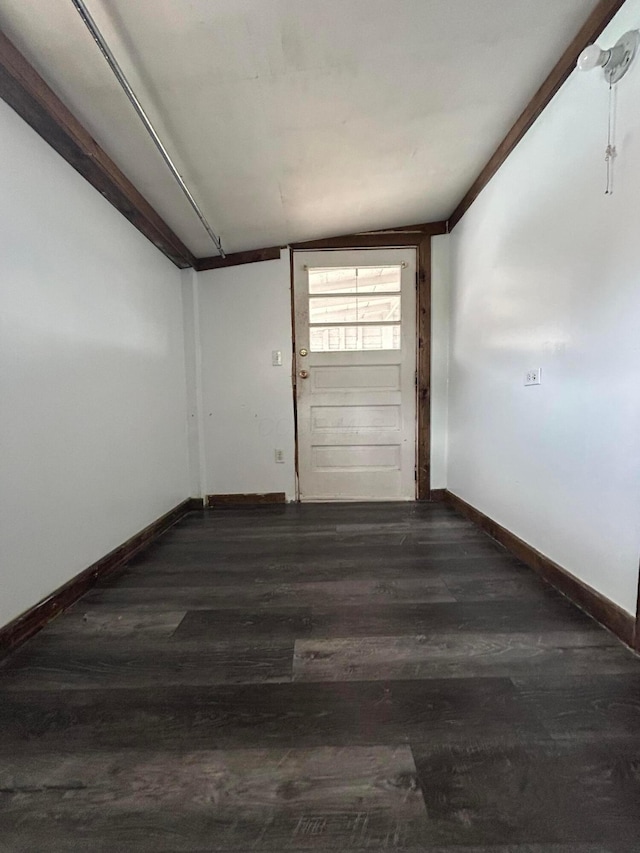 unfurnished room with baseboards and wood finished floors