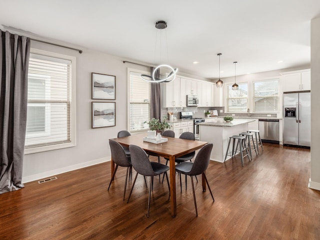 dining area featuring dark wood-style floors, recessed lighting, visible vents, and baseboards