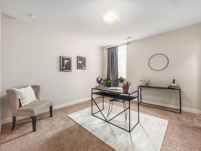 home office with light colored carpet, visible vents, and baseboards