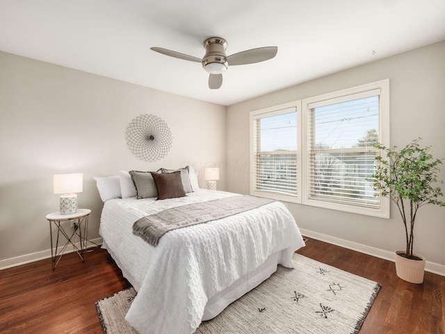 bedroom with ceiling fan, baseboards, and wood finished floors