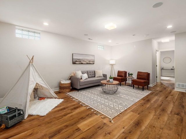 living room featuring recessed lighting, visible vents, and wood finished floors