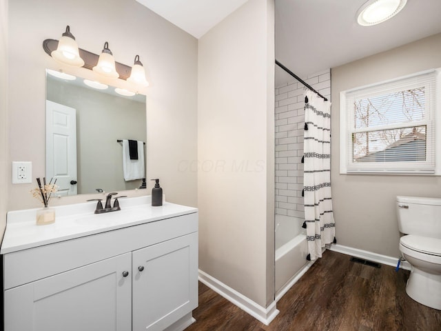 bathroom featuring shower / bath combination with curtain, toilet, vanity, wood finished floors, and baseboards