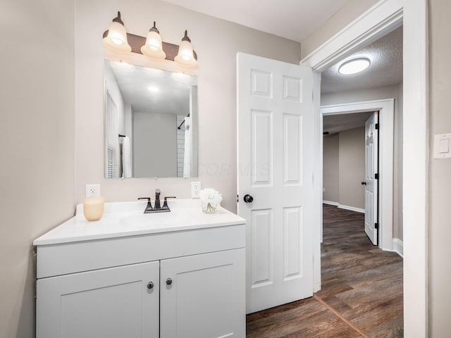 bathroom featuring vanity, a textured ceiling, and wood finished floors