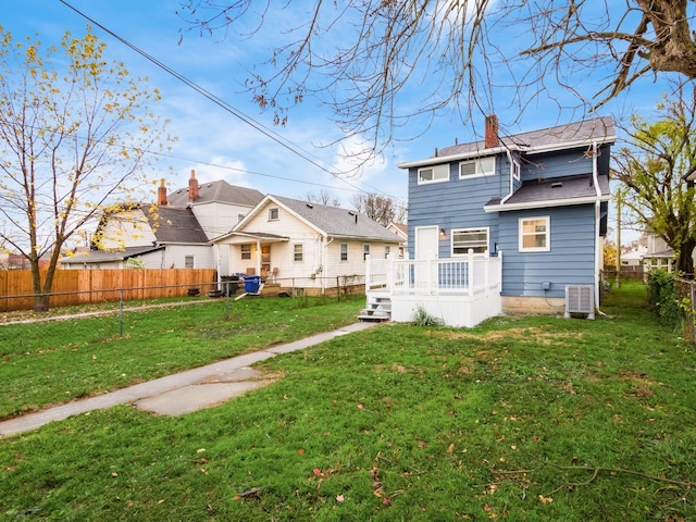 back of house with cooling unit, a fenced backyard, a lawn, a wooden deck, and a chimney