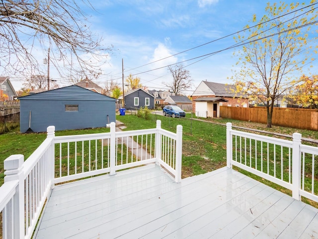 wooden terrace with a yard, an outdoor structure, fence, and a residential view