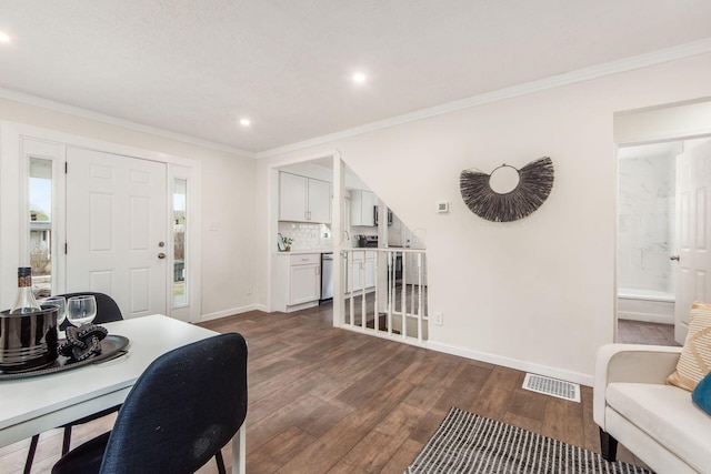 office space with dark wood-style floors, baseboards, visible vents, and crown molding