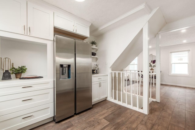 kitchen featuring crown molding, white cabinetry, dark wood finished floors, and stainless steel refrigerator with ice dispenser