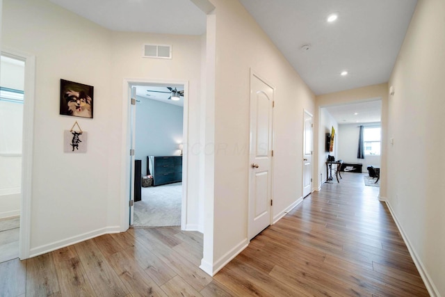 corridor with recessed lighting, visible vents, light wood-style flooring, and baseboards