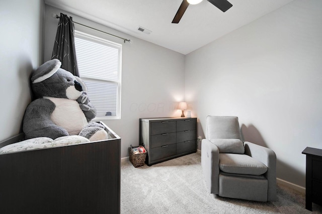 sitting room featuring light colored carpet, visible vents, a ceiling fan, vaulted ceiling, and baseboards