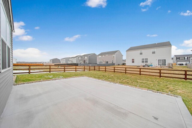 view of patio featuring a fenced backyard and a residential view