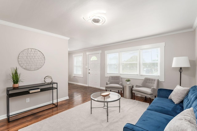 living room featuring baseboards, wood finished floors, and crown molding