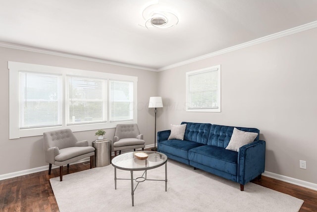 living area with crown molding, baseboards, and wood finished floors