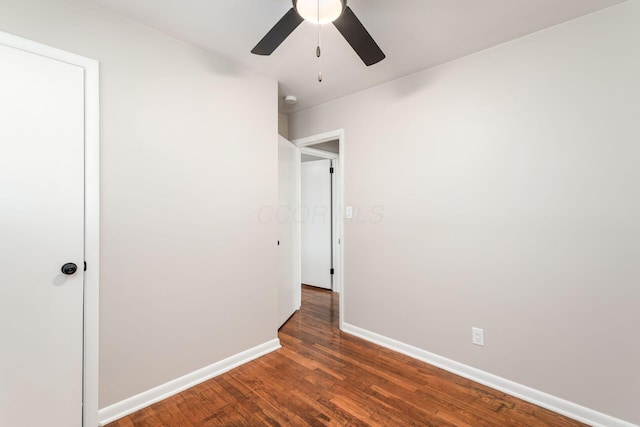 unfurnished bedroom featuring ceiling fan, baseboards, and wood finished floors