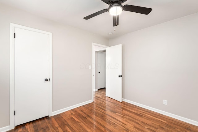 unfurnished bedroom featuring a ceiling fan, baseboards, and wood finished floors