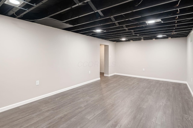 finished basement featuring baseboards and wood finished floors