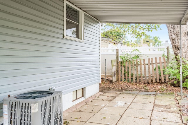 view of patio / terrace with fence and cooling unit