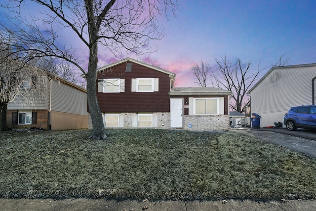 split level home featuring brick siding