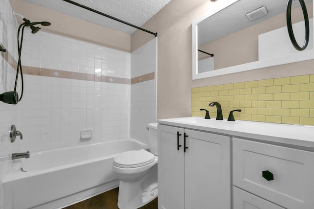 full bath featuring toilet, shower / tub combination, a textured ceiling, vanity, and backsplash