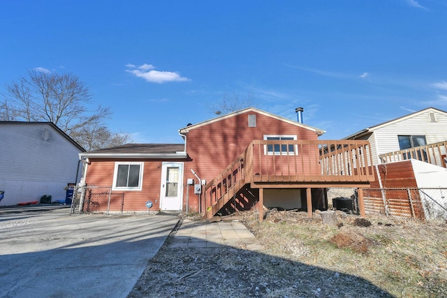 rear view of house featuring stairway and a wooden deck