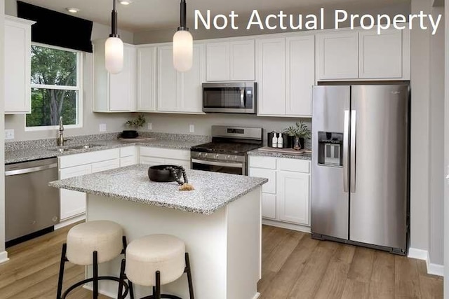 177 Reneau Ave Lot 42, Galloway, OH 43119 - kitchen featuring stainless steel appliances, light wood-style flooring, a sink, and white cabinetry