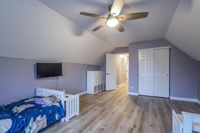 bedroom with lofted ceiling, baseboards, and wood finished floors