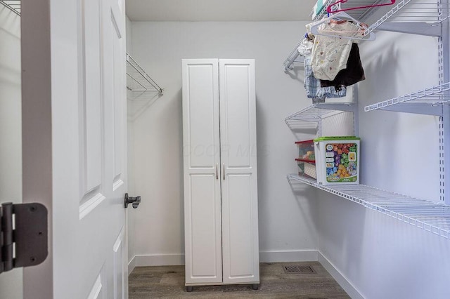 spacious closet with visible vents and wood finished floors