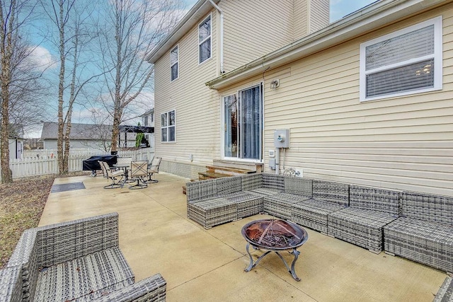 view of patio / terrace with entry steps, an outdoor living space with a fire pit, area for grilling, and fence