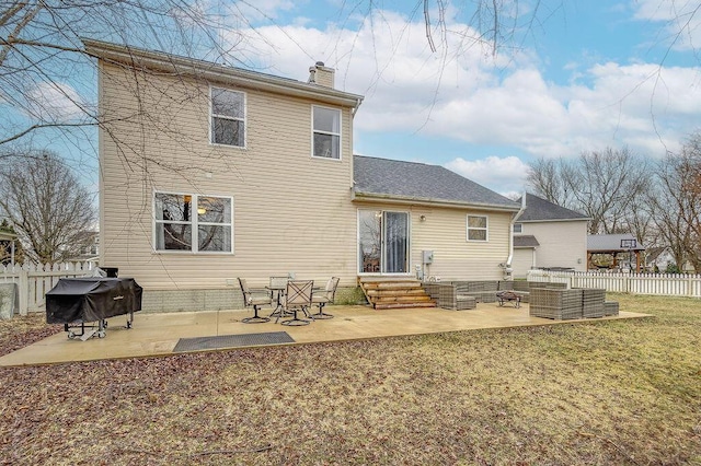 rear view of property featuring entry steps, a patio, fence, an outdoor living space, and a chimney