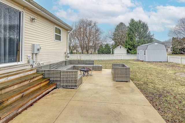 view of patio featuring entry steps, an outbuilding, a fenced backyard, a storage shed, and an outdoor living space with a fire pit